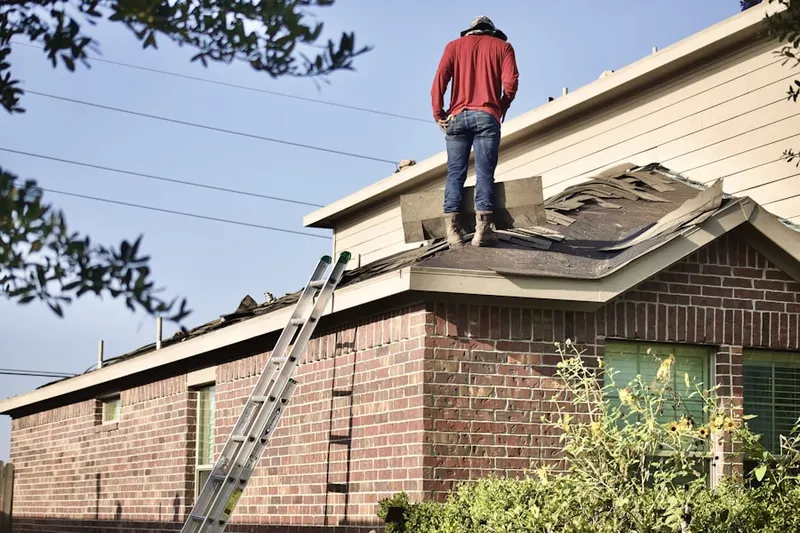 Professional roofer working on a residential roof in Lehigh Acres